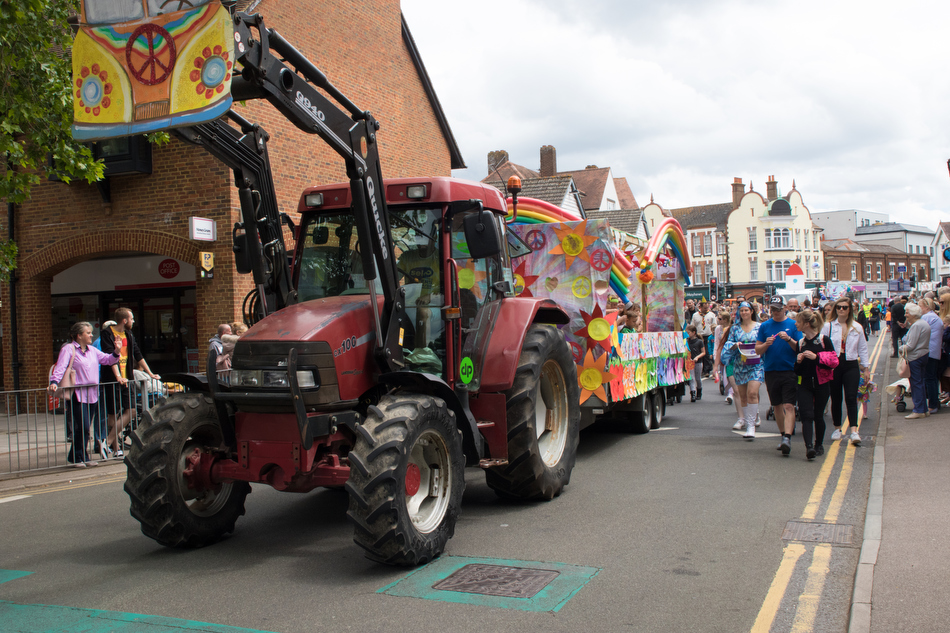 A tractor pulls a carnival float through a town centre